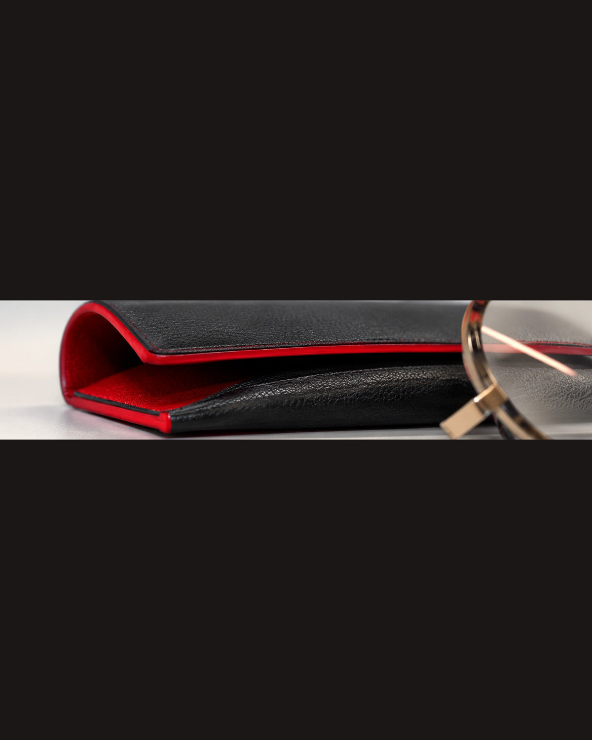 Eyewear case, black leather with red edges