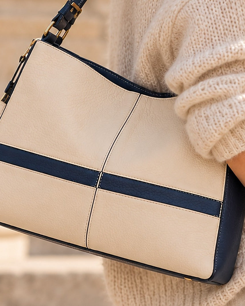 Allure handbag, cream leather with navy band, worn on the shoulder