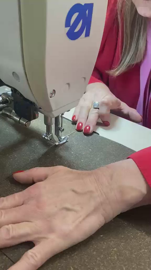 Stitching leather on the sewing machine in the atelier